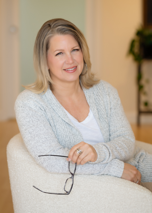 Womans headshot in white chair wearing all white