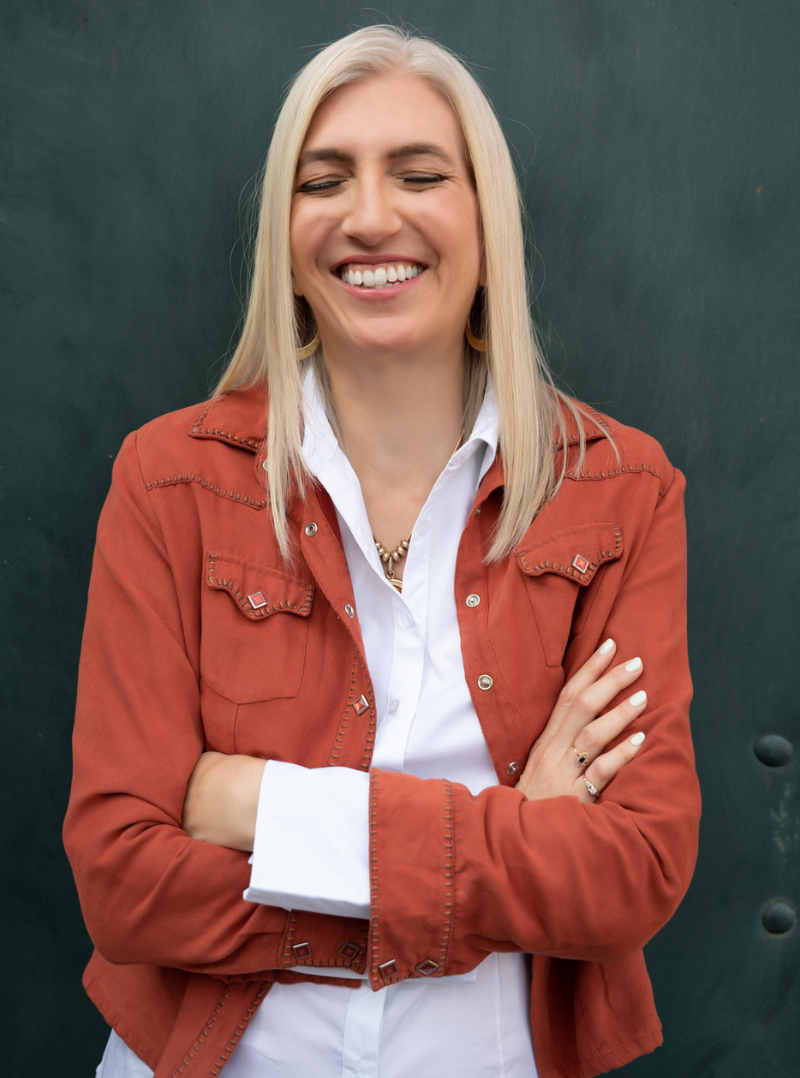 Branding photography of confident woman in orange jacket