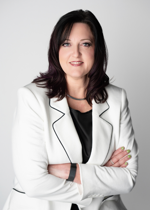 Woman company headshot in white jacket on white background with brown hair