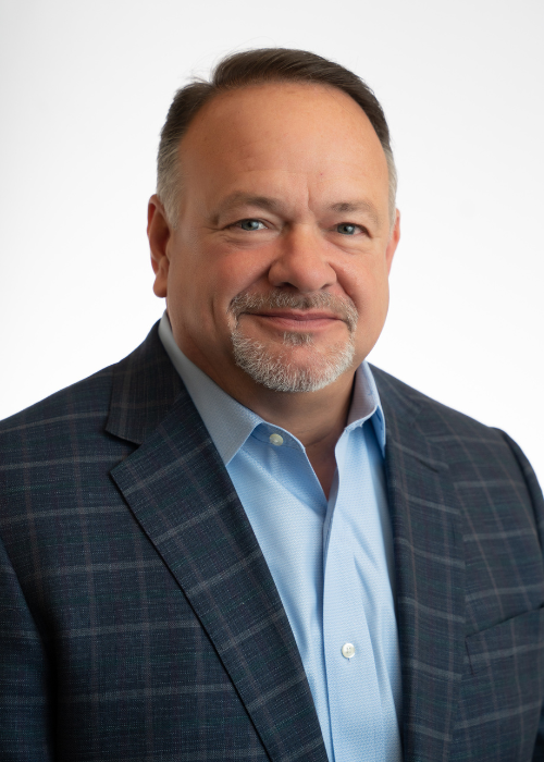 Corporate headshot of CEO and team in suit no tie