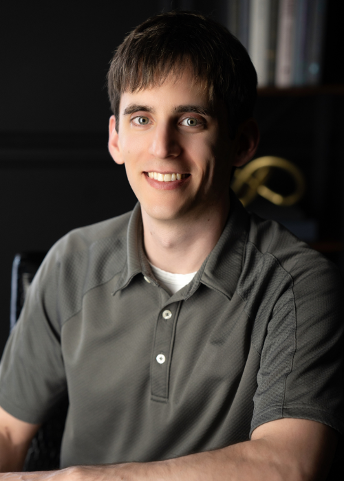 Young man branding photograph in legal office with gray shirt