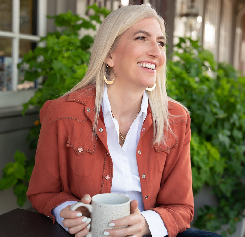 Branding photography of woman with coffee cup in orange blazer