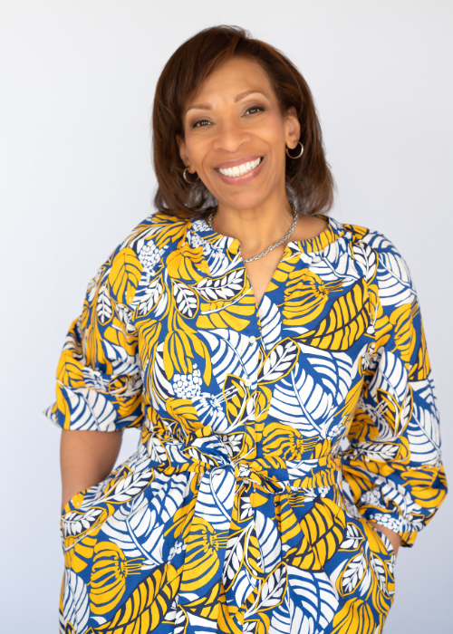 Black woman in bright yellow top with big smile headshot Cary