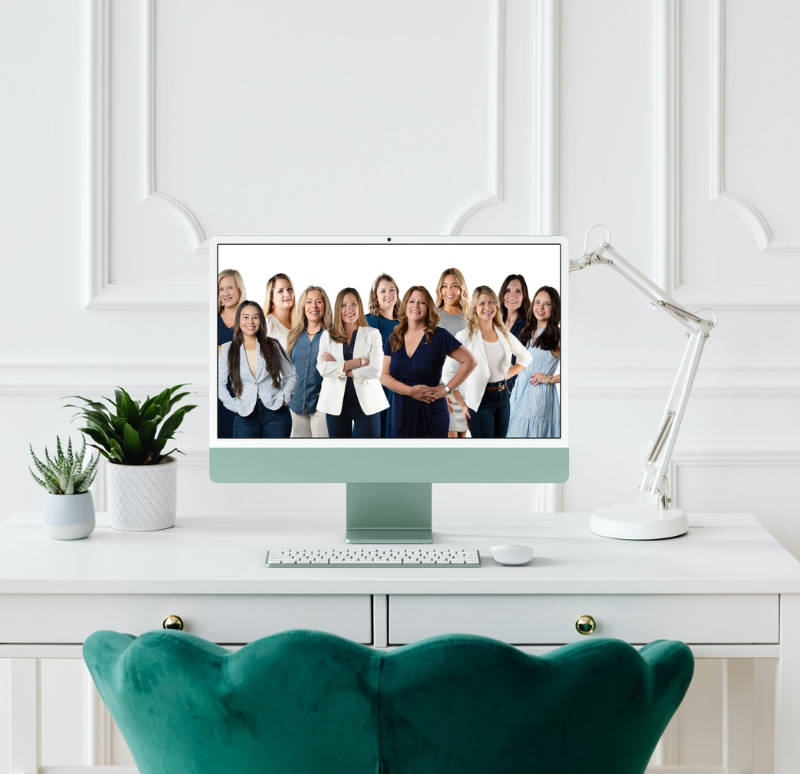 Company headshot of real estate team on computer background with green chair and white desk