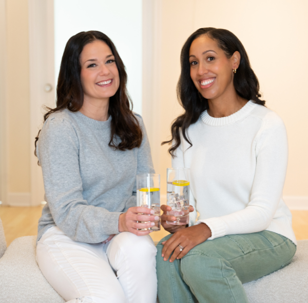 Women business partners holding glasses of water in professional headshots or branding photographs